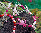 Chain made of fuchsia blossoms and berries
