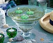 Glass bowl with duckweed and floating candles