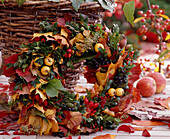 Autumn wreath made of autumn leaves, Malus (ornamental apple), boxwood, Rosa (rosehip)