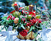 Winter bouquet of roses, proteas, berries and cones