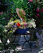 Iron chair, basket with meadow flowers freshly cut
