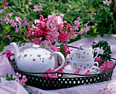Iron tray with tea service, bouquet of Lathyrus (scented vetches)