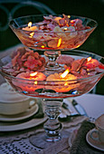 Glass bowls stacked with floating candles