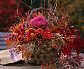 Metal basket with pink (roses and rosehips), chrysanthemum, brassica (ornamental cabbage)