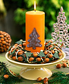 Cake plate with hazelnut wreath and candle