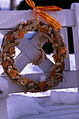 Birdseed wreath with peanuts, apricots, wheat ears, millet cobs