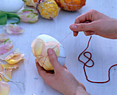 Easter eggs decorated with petals: Wrap petals around eggs with boullion wire