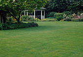 View over lawn to open pavilion and perennial bed