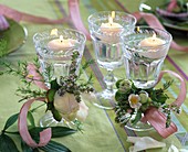 Wine glasses with floating candles decorated with paeonia (peony)