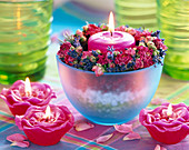 Rose candles, blue bowl with decorative gravel