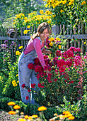 Young woman picks flowers bouquet