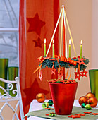 Hanging small advent wreath on stick in red pot