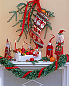 Embroidered, filled Father Christmas stocking with a branch of Picea (spruce)