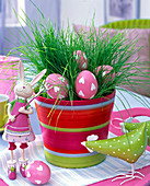 Easter nest made of Easter grass in a ringed planter, Easter eggs, rabbit, chicken