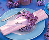 Napkin ring from Syringa vulgaris around pink striped napkin