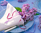 Syringa vulgaris (Lilac, purple) in white cloth napkin