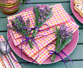 Bouquets with lavandula on checkered napkins on pink