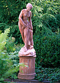 Terracotta figure 'Woman with towel' on pedestal