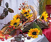 Basket with Helianthus (sunflowers), rose hips and Aesculus (chestnuts)