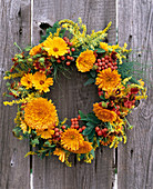 Late summer wreath with marigolds and rowanberries