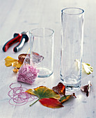 Glasses wrapped with autumn leaves as lanterns (1/3)