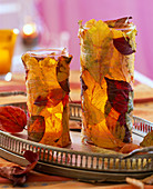 Glasses wrapped with autumn leaves as lanterns (3/3)