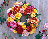 Wreath of pink (roses, yellow, pink, red, striped) and Rubus (blackberries)