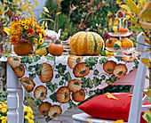 Various Cucurbita (pumpkin) on table, bouquet of Rudbeckia