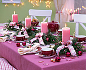 Advent wreath of pink candles in arrangements of Calluna and Cryptomeria