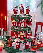 Advent calendar of small red buckets hung on a frame