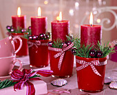 Advent wreath with pinus, red candles, Christmas tree decorations, ribbon