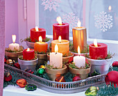 Arrangement of red, white, orange and gold pillar candles