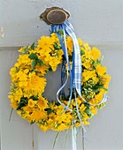 Door wreath of dandelion and buttercup flowers