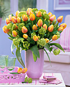 Bouquet of Tulipa (tulips) with closed flowers and Viburnum (snowball)