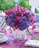 Bouquet of hydrangea and sweet pea in a blue and white patterned vase