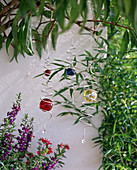 Metal spirals with coloured glass balls to hang up as decoration