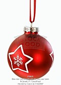 A red Christmas tree ornament with a white star