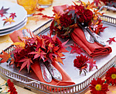 Small wreaths of chrysanthemum and autumn leaves of Acer