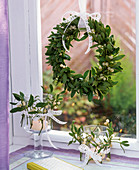 Wreath of Viscum album (mistletoe) at the window, lanterns decorated with mistletoe
