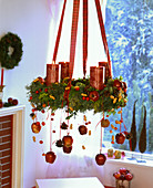 Hanging Advent wreath with Malus (apples, ornamental apples), Arachis (peanuts)