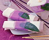 Napkins with Zantedeschia (indoor calla) wrapped in purple tissue paper