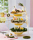 Easter nests in etagere with wreaths of Salix (willow, catkin willow), Buxus