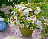 Bouquet from Syringa, Leucanthemum, Euphorbia