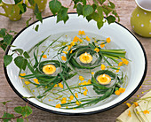Grasses around tea lights, Ranunculus (buttercup) floating in a bowl