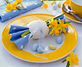 Narcissus on ruffled napkin, blown easter egg