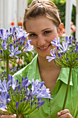 Woman with Agapanthus africanus (African ornamental lily)