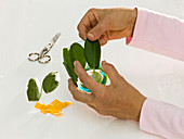 Dahlia flowers in glasses with rhododendron leaves (3/6)