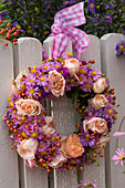 Wreath of pink (roses and rose hips), aster (autumn asters) with pink -