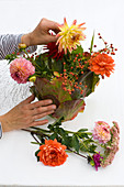 Dahlia bouquet in foliage vase 5/6