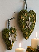 Hearts of moss decorated with stars of bark and orange peel